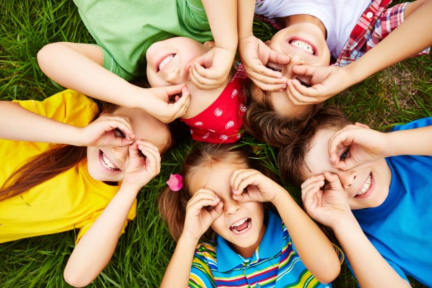 Children laying on grass